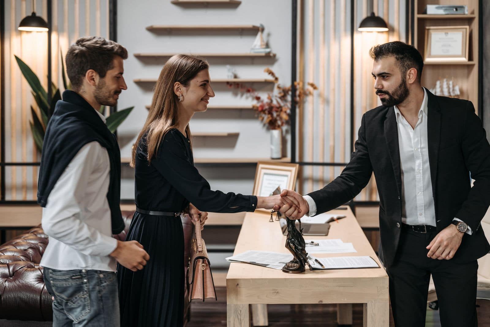 Business partnership handshake in a modern office